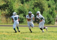 Juniors Michael Horan, Michael Foster, and Brandon Perroots run a play (Photo by: Laurie Young)