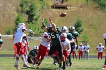 The Wolves put pressure on the opposing QB as he throws the ball (Photo by: Liz Magyar)